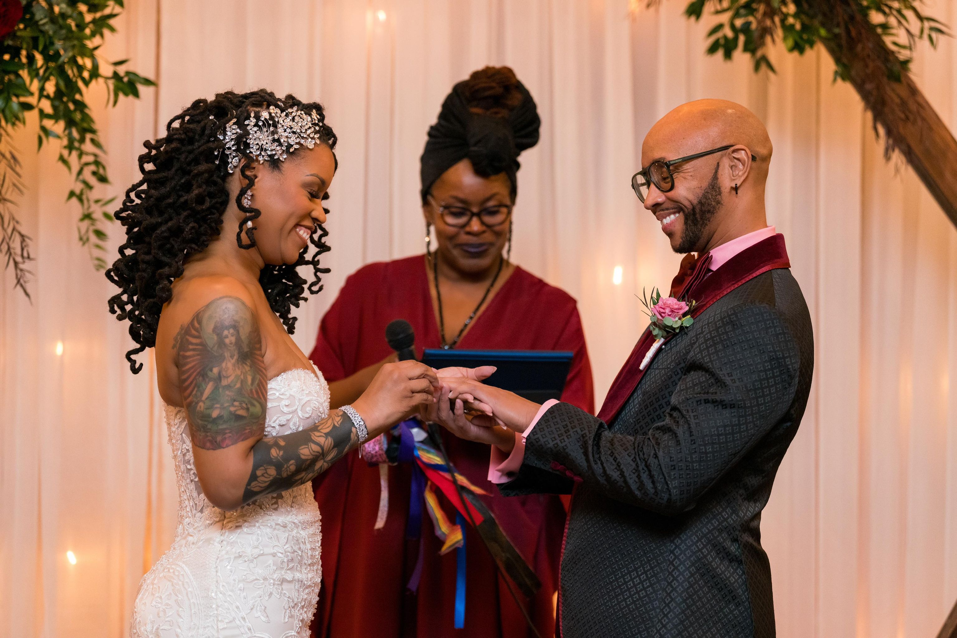 Ceremony photo of Dr. Tre with the happy couple